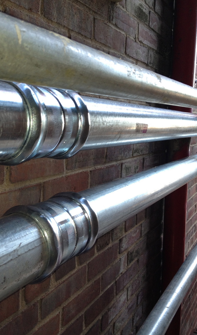 Pipes Picture of conduite attached to brick wall